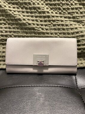 Michael Kors light grey clutch wallet with silver hardware